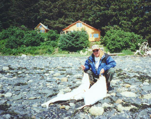 Two large halibut on the beach.